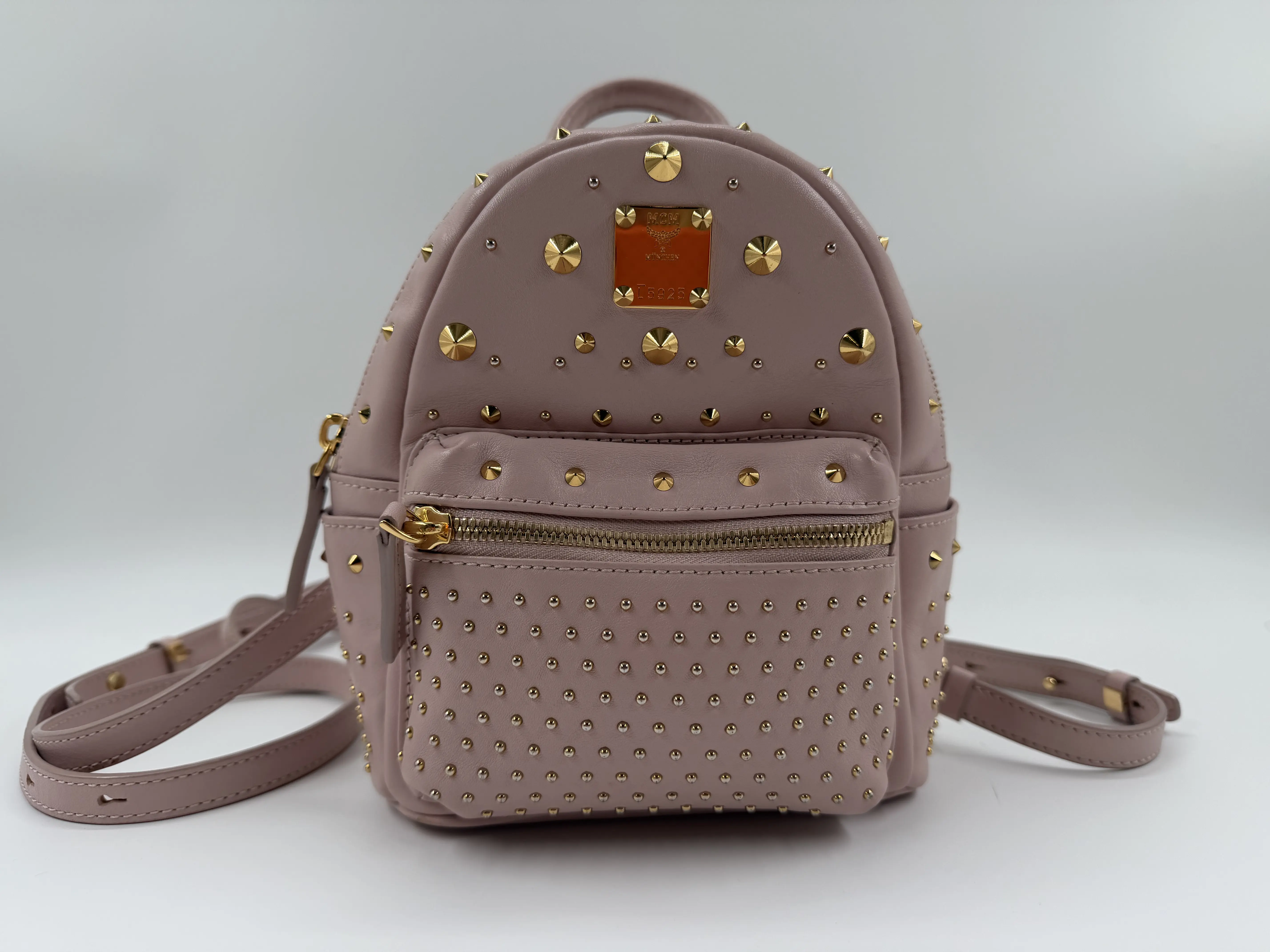 Pre-owned MCM calfskin Backpacks Stark Mini Backpack Rose Pink Leather with Gold Studs & Red Logo Plaque B2706662701