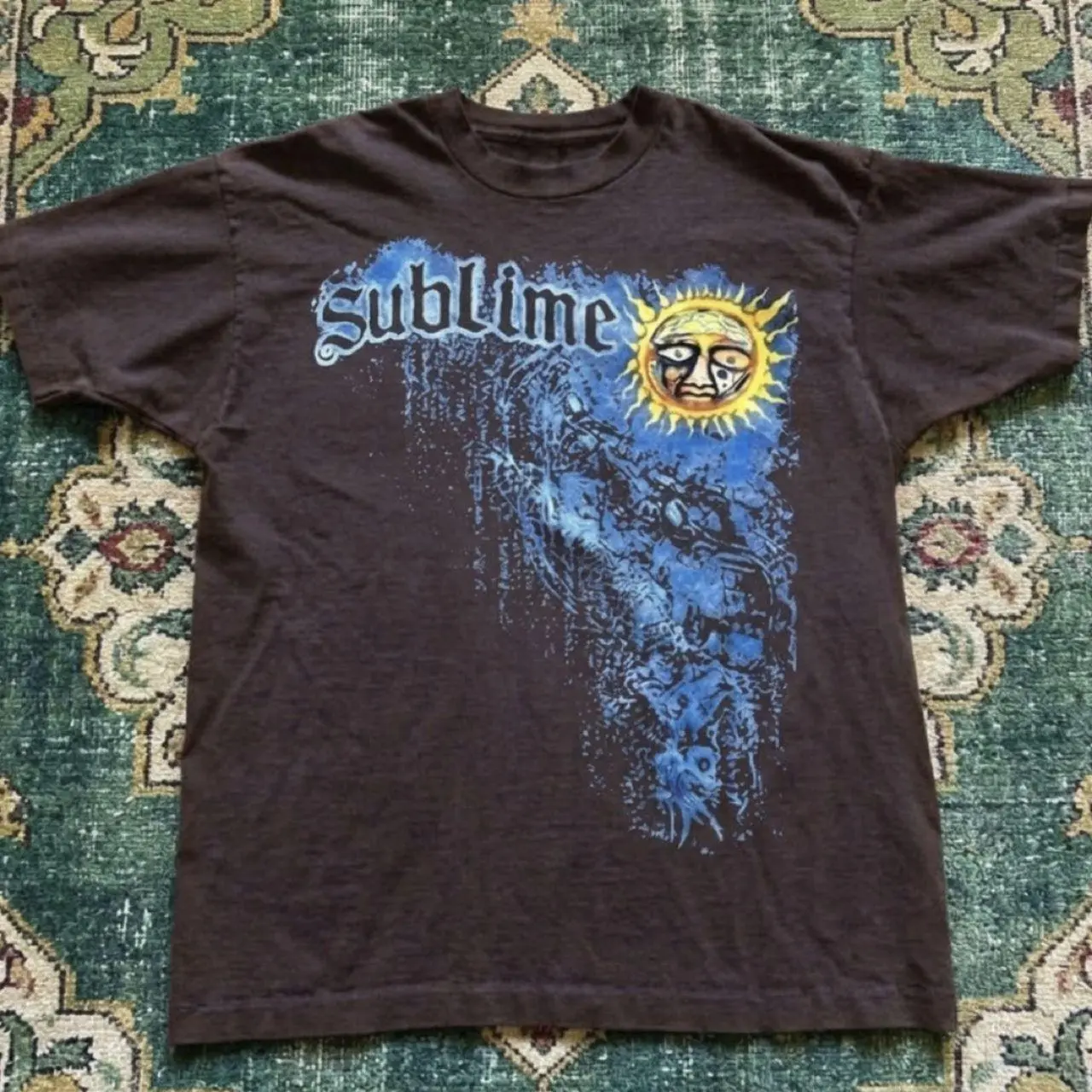 Sublime band tee with blue graphic of a figure with a sun face shirt