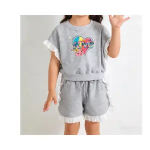 Charming two-piece outfit for girls, including a short-sleeved T-shirt with lace floral pattern and lace-trimmed shorts, perfect for summer outdoor wear