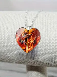 A transparent glass heart necklace with a 2D dragon and sword design inside.