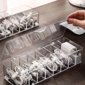 A cable storage box with a lid, Multi compartment, designed to hold data cables, chargers and accessories, to achieve a tidy desk arrangement and to store cables.