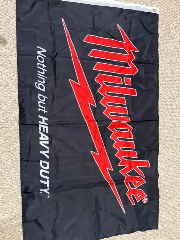 Black Milwaukee flag red writing "nothing but heavy duty"
