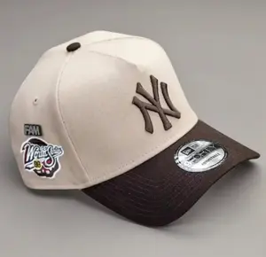 9FORTY New York World Series Side Patch Baseball Cap – Cream & Brown, Adjustable Size, Brown NY Logo.