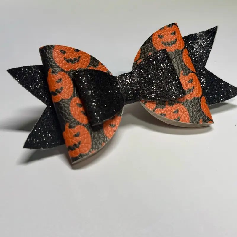 Ruby Bowtique Halloween Black Pumpkin Hair Bow with Glitter Accents and Pumpkin Face Design for Festive Outfits