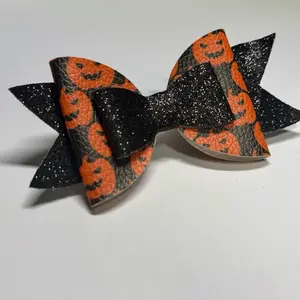 Ruby Bowtique Halloween Black Pumpkin Hair Bow with Glitter Accents and Pumpkin Face Design for Festive Outfits
