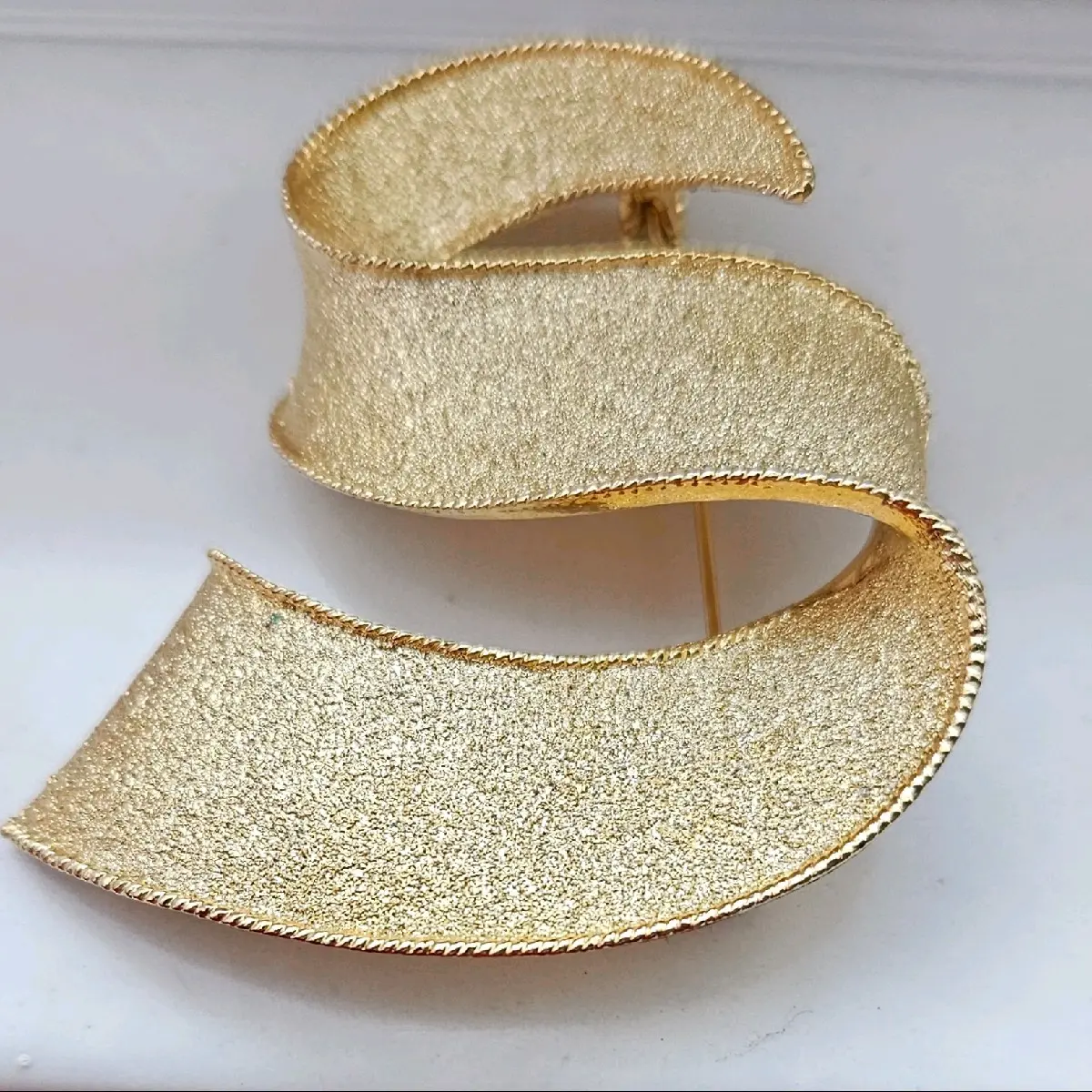 Park Lane Signed Textured Gold-tone Satin Swirl Ribbon Brooch.