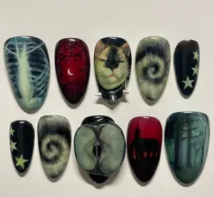 Dark gothic nails featuring eerie cat art, ribcage, forest silhouettes, stars, and surreal spirals for a mysterious, moody, and hauntingly artistic aesthetic