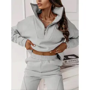 Women’s two-piece set featuring a solid-color crewneck pullover with long sleeves, paired with loose-fit pants and an elastic waistband; suitable for various occasions and available in diverse styles.