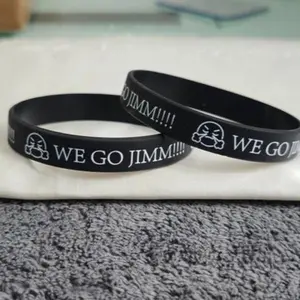 JimmBand - Black Wristband with "WE GO JIMM!!!" Text, Featuring Character Design, Ideal for Fans and Supporters