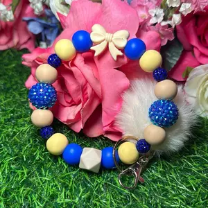 Bedtime story Wristlet Keychain color scheme royal blue, nude, pastel yellow and bling beads made with wire
