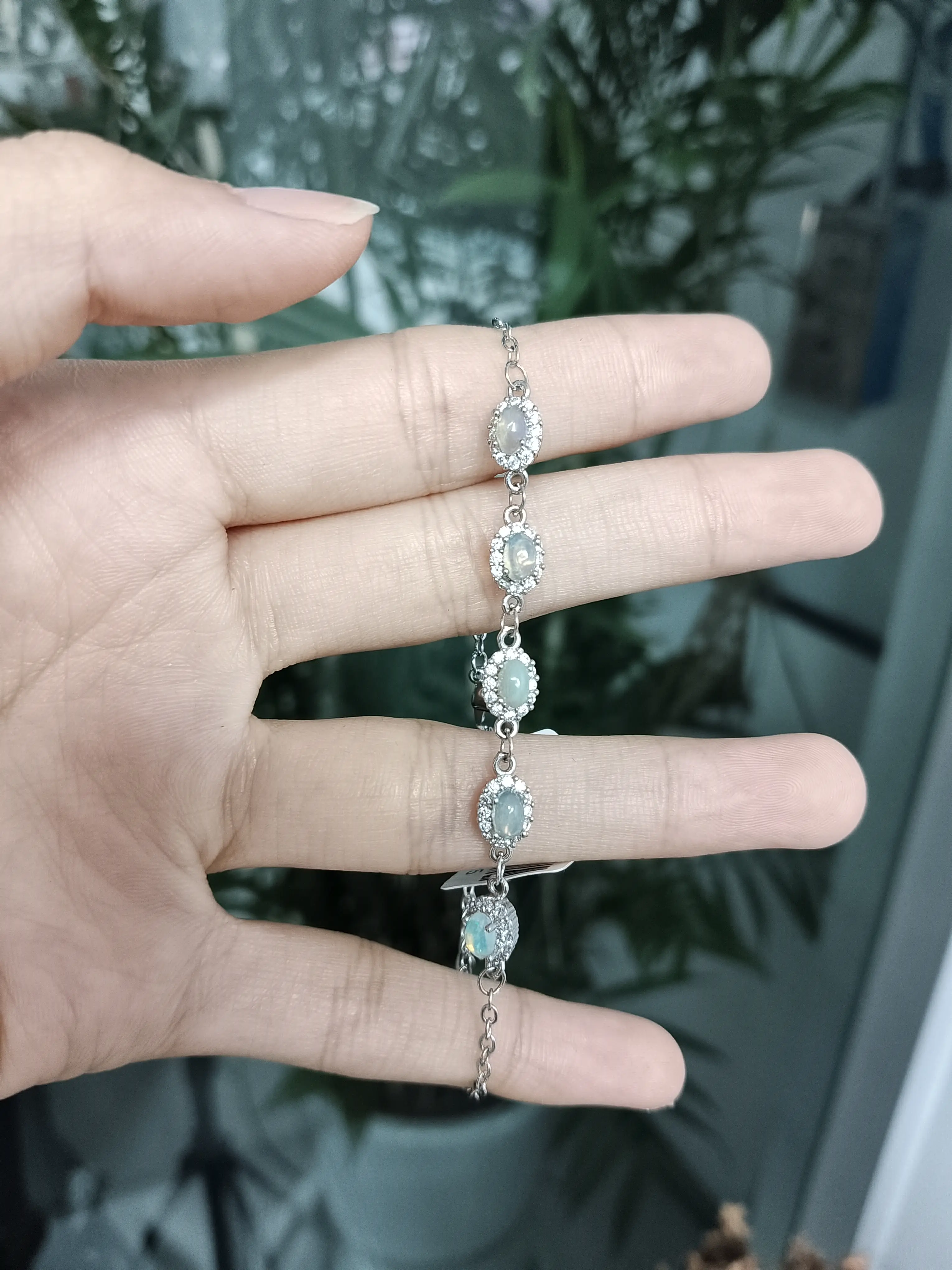 Ina(24592)gc.Beautiful five‑stone opal link bracelet set in 925 sterling silver. Each oval opal glows with soft play‑of‑color, framed by sparkling cubic zirconia.