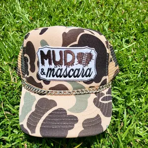 Mud and Mascara foam trucker hat with embroidered patch.