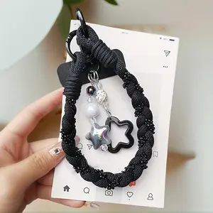 Short Phone Lanyard with a Stylish Pendant, Wrist-Length Design for Outdoor Use, And a Protective Strap to Prevent Dropping The Phone.