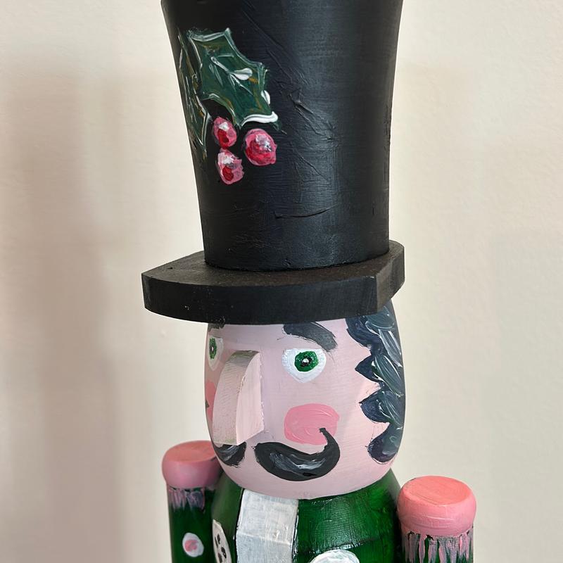 Hand-painted wooden nutcracker. He measures 24 inches tall. “Gunner” is a handsome guy that absolutely can live in your space year round.