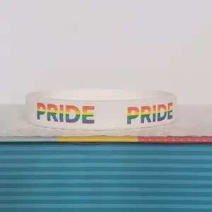 LGBTQIA+ PRIDE Silicone Wristband showing "PRIDE" all around the band. Rainbow letters over a white band. Our original and discontinued line, adopt yours today before it's sold out. = )