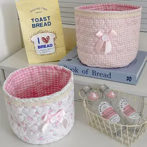 Cute lace bow patchwork storage basket, round fabric desktop organizer box, Instagram-style plaid print storage bin, soft padded makeup storage box, attractive pink bow storage bucket, foldable desktop storage basket