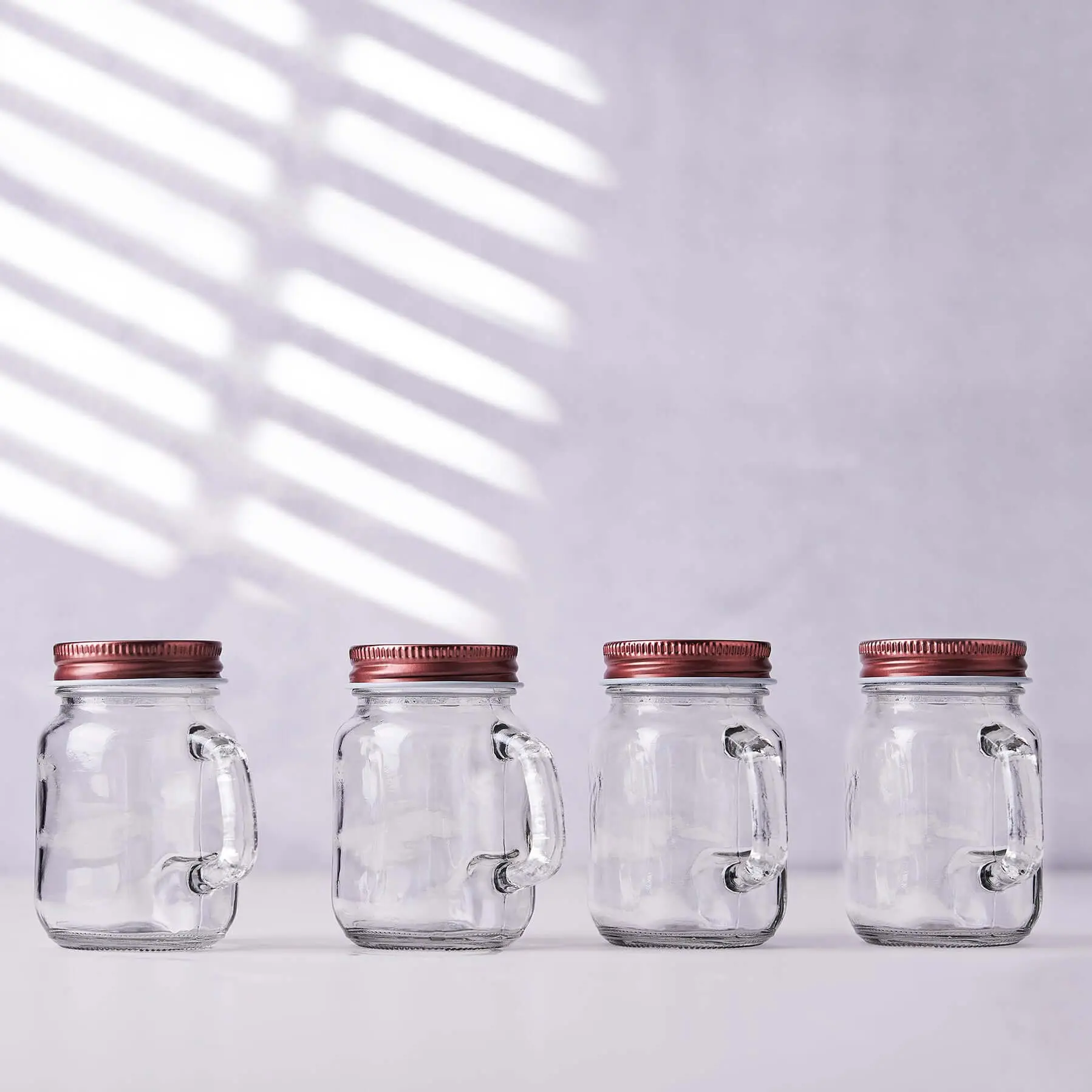 4-Pack Clear Glass Mason Jars 4oz Rustic Design with Handles and Rose Gold Screw-On Lids - Stylish Storage for Beverages & Decor