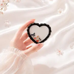 Starlight Fantasy shaker grip with a black scalloped heart design and small acrylic charms inside