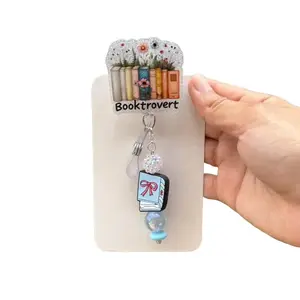 Booktrovert badge reel with removable beaded matching charm.
