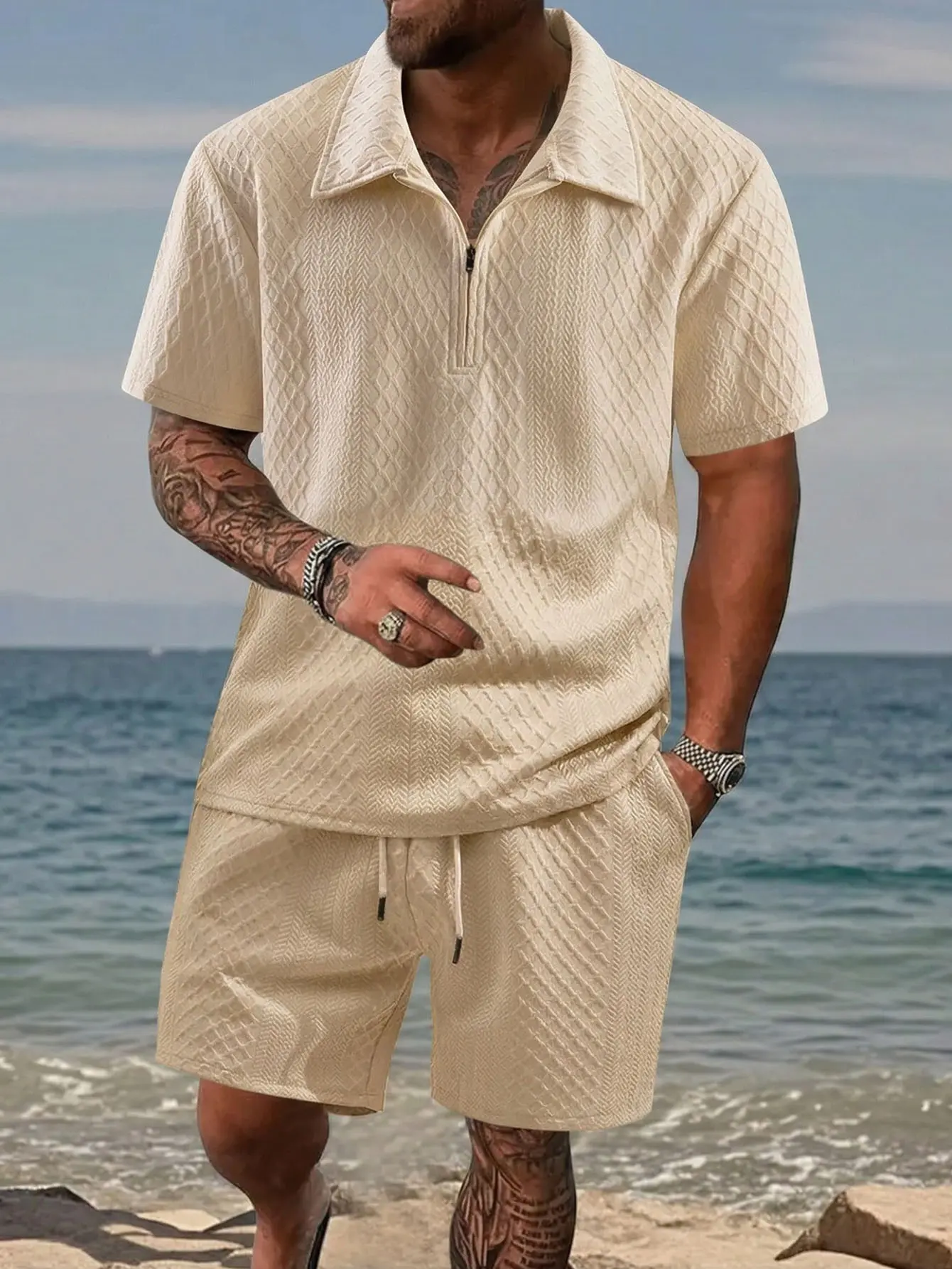 Men’s casual two-piece set featuring a turn-down collar short top with half-zip and drawstring, paired with shorts; jacquard design with 3D texture, suitable for everyday summer wear and commuting.