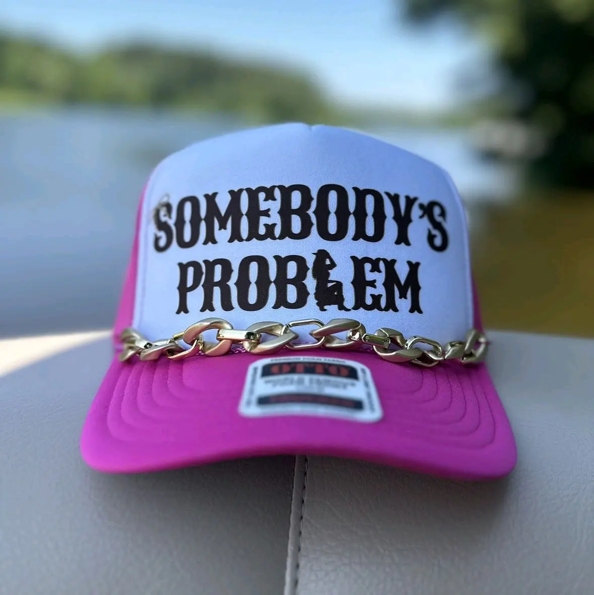 Somebody's Problem dtf transfer on a foam trucker hat with hat chain.