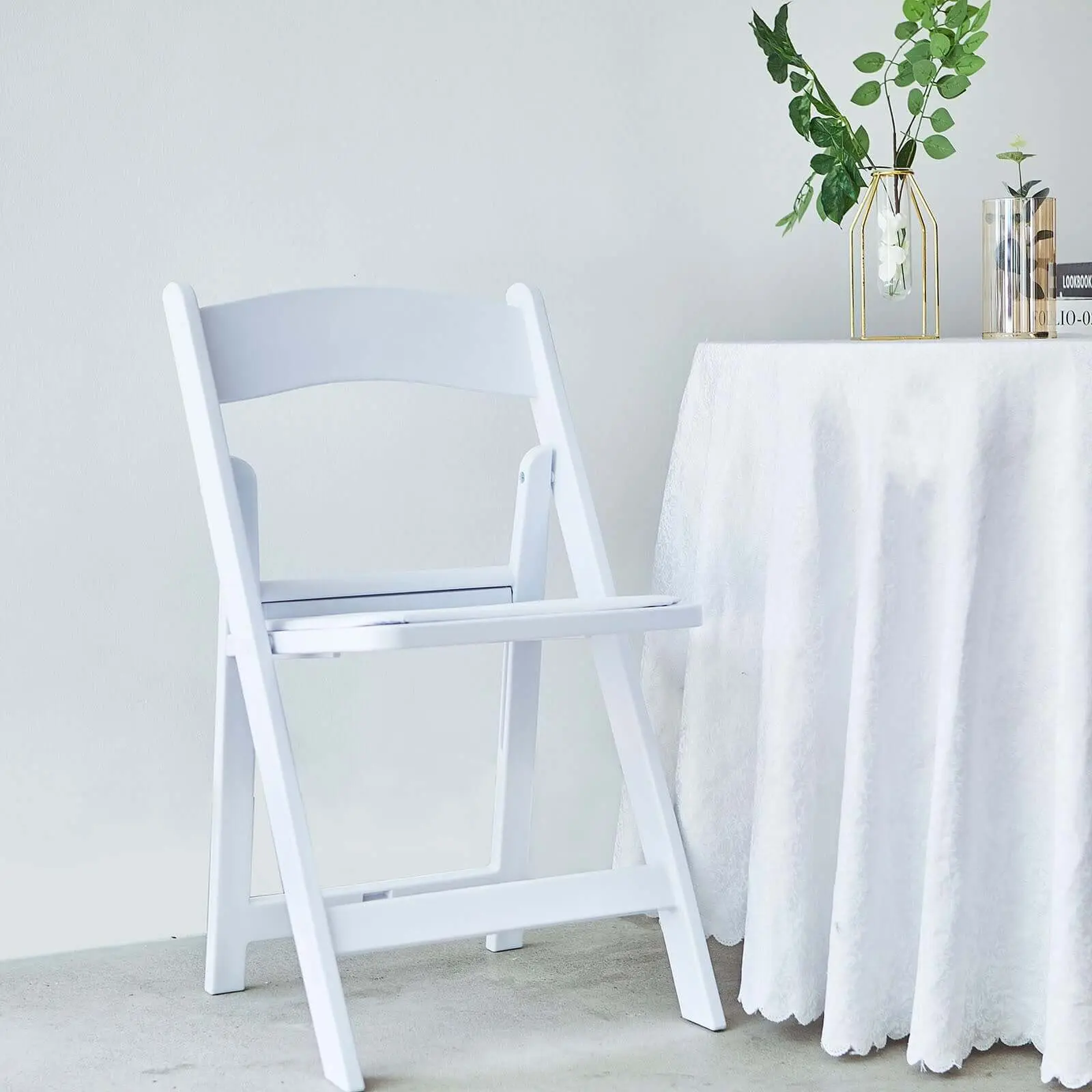 White Resin Folding Chair with Resin Frame, Foam-Vinyl Padded Seat, Fire Retardant, Built-In Stacking Feature, Durable Space-Saving Indoor Furniture for Weddings, Game Halls, Business Events