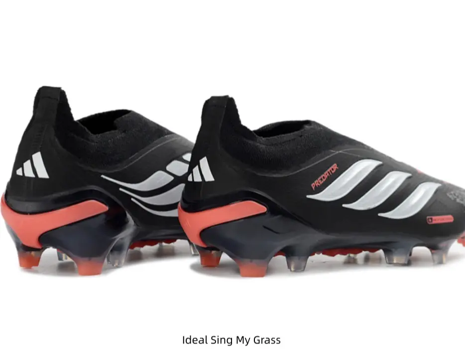Sleek Black Laceless Soccer Cleats Shiny Silver Side Branding Vibrant Orange Heel & Stud Accents Competition Training Firm Ground Boots