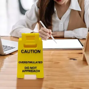 Overstimulated Desk Warning Sign - Yellow Sign with Black Text, Funny Joke Gift for Colleagues, Boss & Employees, Small Novelty Desk Decoration