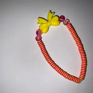 Yellow Bow Bracelet with Red Striped Design and Pink Beads