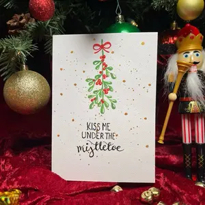 Hand-painted Watercolor Christmas Card with Mistletoe Design and Festive Bow Kiss Me Under the Mistletoe