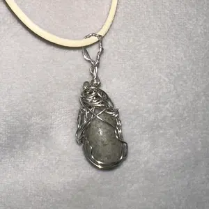 Pyrite stone necklace set in silver wire with complementary white chain.