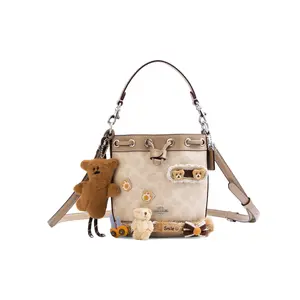 Coach Dempsey Mini Handbag for Women – Light Khaki Teddy Bear Decor, Premium Canvas and Leather, Drawstring Closure
