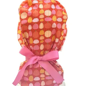 Pink pumpkin in orange scrub cap