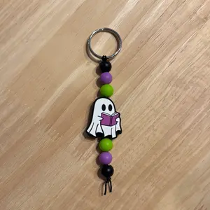 Dual Sided Ghost Reading Silicone Keychain with black, purple and green Beads