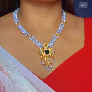Two layer pearl necklace with gold plated pendant and earrings