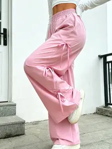 A pink high-waisted wide-leg cargo pants with a bow tie sash, featuring a loose and floor-grazing fit, casual fashion pants. It is suitable for autumn and winter, and ideal for home wear, indoor activities and outdoor outfits
