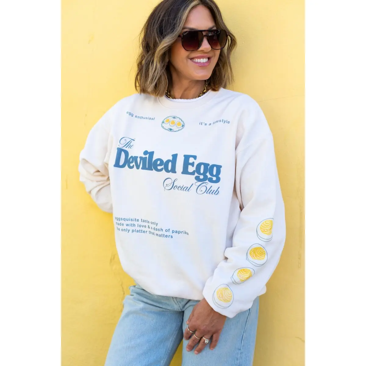Women's "The Deviled Egg Social Club" Graphic Crewneck Hoodie - Cream, Soft Retro Round Neck, Tasty Left Sleeve Print, Casual, for Halloween Party Lovers, Tops