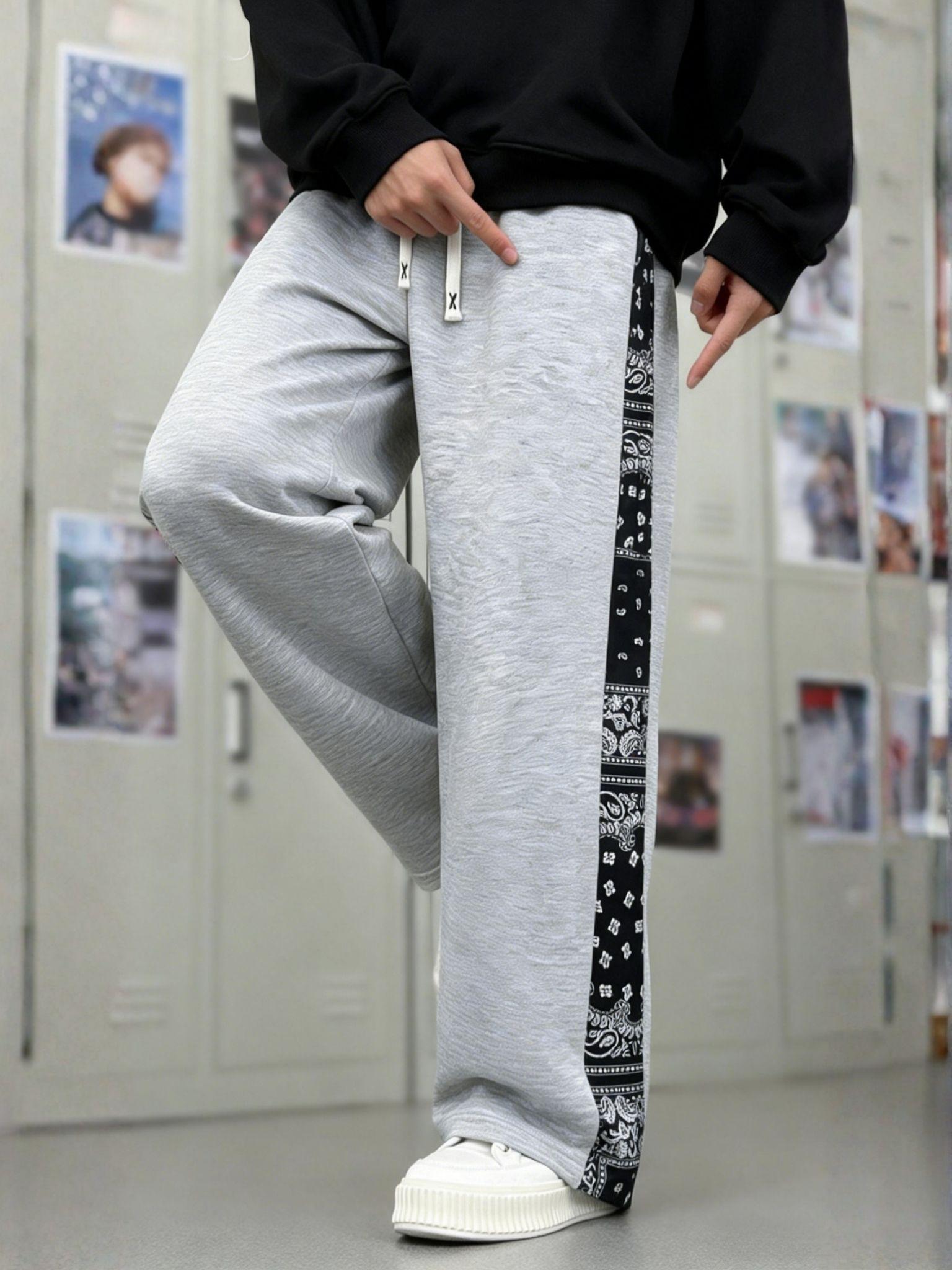 Men’s casual pants featuring an elastic waistband and drawstring design, floral side pattern, side pockets, and slight stretch—comfortable athletic casual pants.