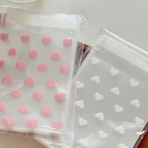 Soft white heart-shaped transparent self-sealing gift bag, large capacity, 100 pieces per pack, 3.12x5.12 inches, food-grade packaging bag, couple's festival candy bag, girl-style handmade small gift, birthday gift packing bag