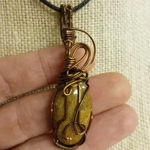 Yellow moss agate, gold tones and much depth in antique bronze.