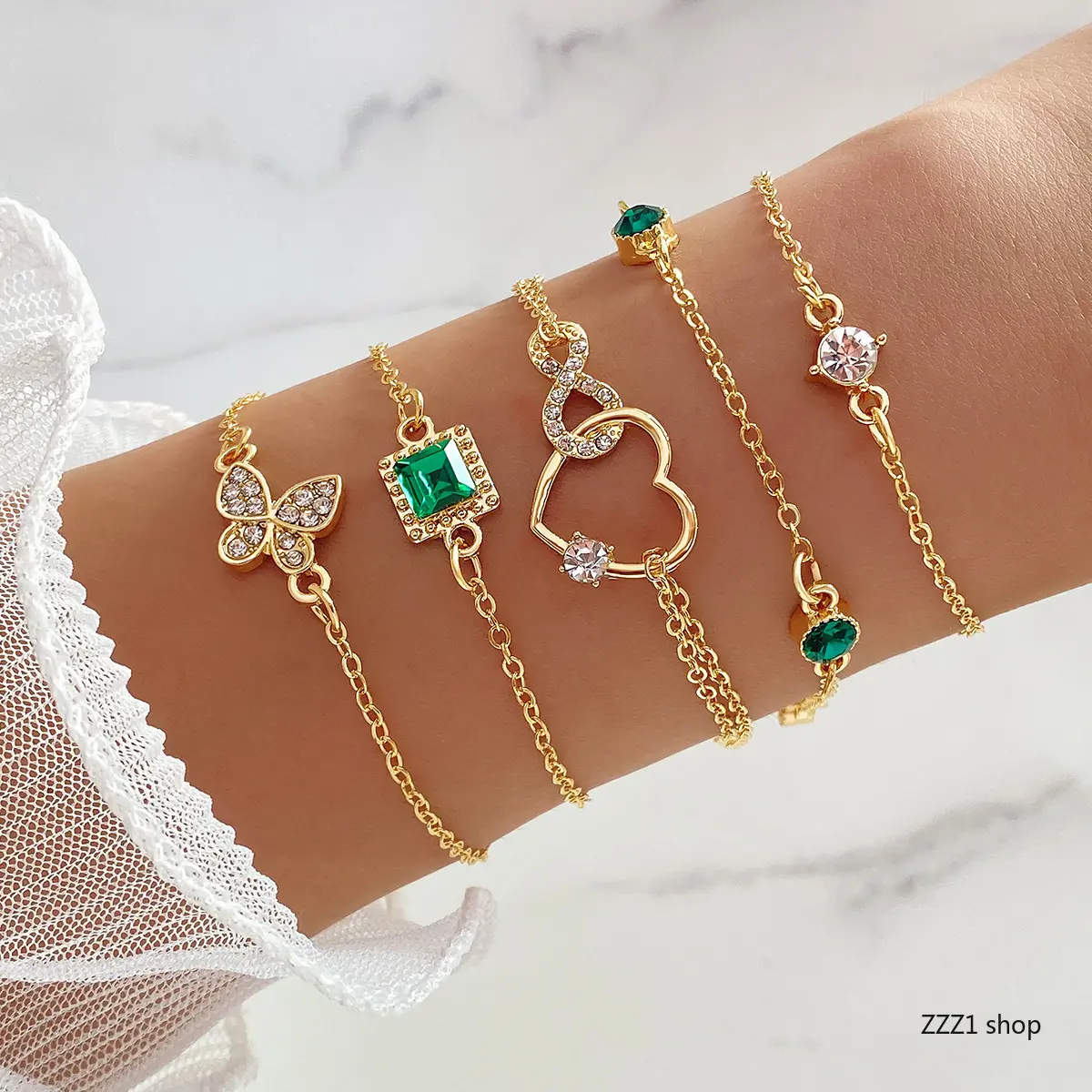 Women's Fashion Wrist Jewelry, 4-Piece Gold Layered Bracelet Stack with an Emerald CZ, Rhinestone Butterfly, Crystal Heart & Infinity Charms, Stacked Design Bracelets, Rhinestone Decorated Bracelet