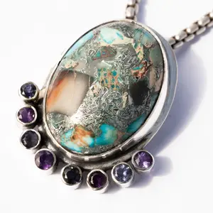 Regalite with Facets of  amethyst and iolite facets perfectly compliment the colorful stone.