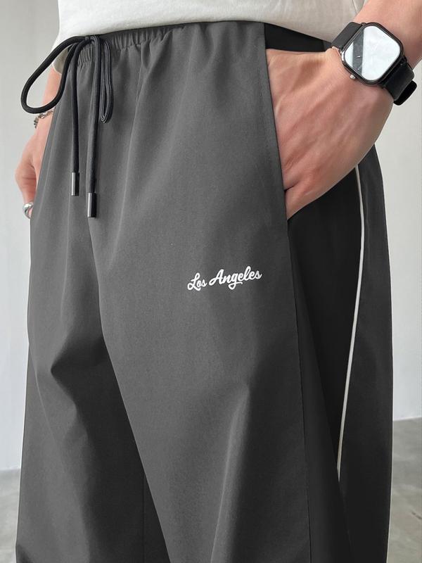 Men's Black Colorblock Sweatpants with White Side Stripes & Embroidered Design for Gym Wear, Loose Athletic Long Pants, Sporty Elegance, Drawstring Waist, Straight Leg Cut, Trendy Street Fashion Joggers Sports Menswear Embroidery Embroidery Tracksuit