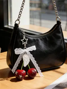 Y2K Gothic cherry keychain with lace bow, star, pearl and wing accents. Versatile bag charm for handbags and backpacks. Perfect accessory and gift for Y2K style lovers, ideal for daily wear and music festivals.