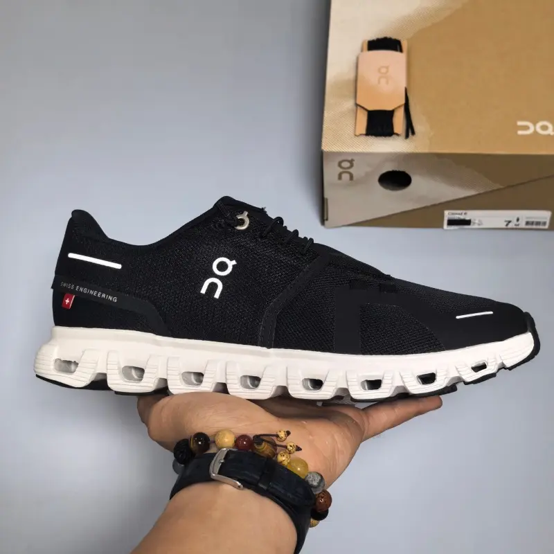 Breathable knit mesh lifestyle running sneakers built for clean understated everyday sport street aesthetics, matte jet-black mesh shell layered with slim reflective white trim detailing, porous ventilated mesh panels