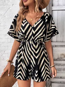 A women's black and off-white zigzag patterned V-neck romper with puff sleeves and a cinched waist, Fitted, featuring a vintage yet slightly edgy look, suitable for relaxed and casual occasions like weekend outings or gatherings with friends