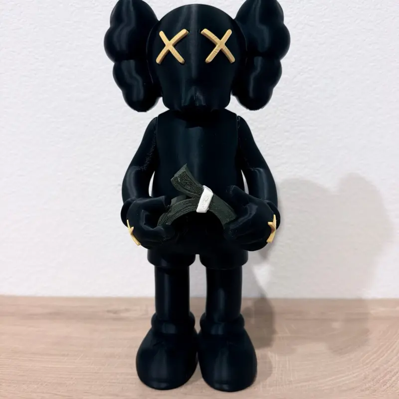 Money themed figure with gold X eyes