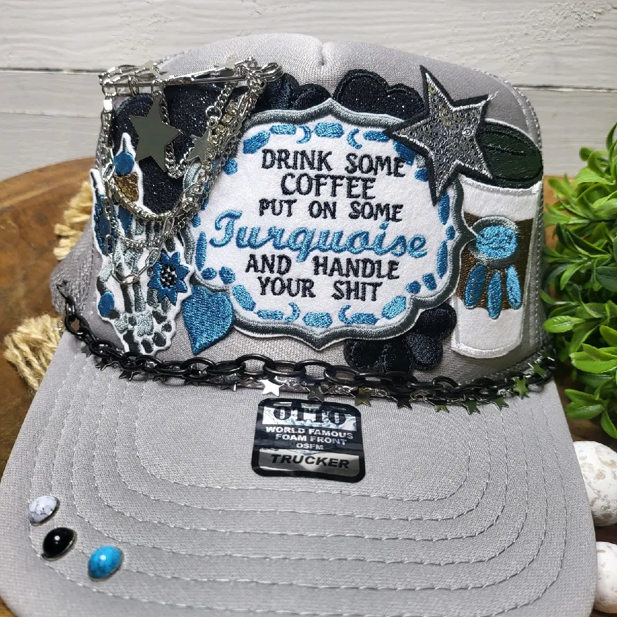 Coffee and Turquoise foam trucker hat with silver accesories.
