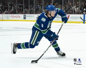 Brock Boeser Vancouver Canucks Unsigned Blue Jersey Shooting Photograph