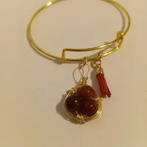 Goldtone Bangle Bracelet with Wire-wrapped Bird Nest and Rust Color Tassel